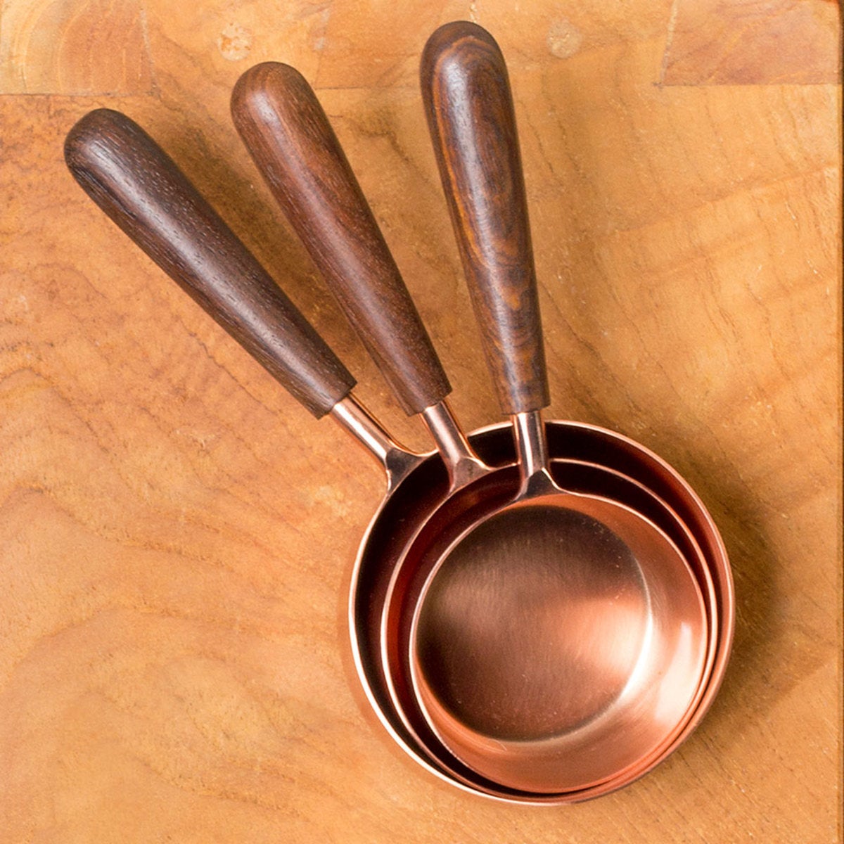 https://www.vivaterra.com/images/v2297-handcrafted-copper-measuring-cups.jpg_1200Wx1200H.jpg?format=1200Wx1200H